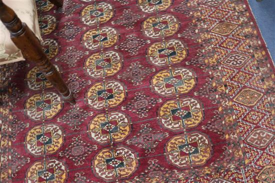 A Bokhara red ground rug 175cm x 117cm